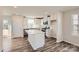 Modern kitchen with stainless steel appliances, a center island, and sleek white cabinets at 1171 Blackburn Cir, Edgemoor, SC 29712