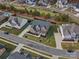 Aerial view of a brick two story home with manicured lawn and landscaping in a suburban neighborhood at 120 Trelawn St, Fort Mill, SC 29715