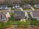 Aerial view of a brick home with a covered patio and landscaped lawn in a residential neighborhood at 120 Trelawn St, Fort Mill, SC 29715