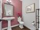 Chic half bathroom with a pedestal sink and accent wall at 120 Trelawn St, Fort Mill, SC 29715