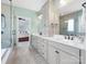 Bright bathroom featuring a double sink vanity with plentiful storage, quartz countertop, and a glass enclosed shower at 120 Trelawn St, Fort Mill, SC 29715