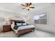 Bright bedroom features a ceiling fan, large window, and a neatly made bed with throw pillows at 120 Trelawn St, Fort Mill, SC 29715