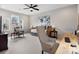 Bright bedroom features a ceiling fan, large window, and a desk at 120 Trelawn St, Fort Mill, SC 29715