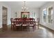 Elegant dining room with wood floors, large windows, and stylish chandelier at 120 Trelawn St, Fort Mill, SC 29715