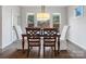 Bright dining room with large windows, hardwood floors, and stylish furniture at 120 Trelawn St, Fort Mill, SC 29715