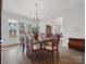 Spacious dining room with ample natural light, featuring dark hardwood floors and detailed trim at 120 Trelawn St, Fort Mill, SC 29715