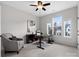 Serene home office with a desk, chair, and natural light from large windows overlooking the neighborhood at 120 Trelawn St, Fort Mill, SC 29715