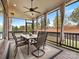 Screened-in patio offers a peaceful outdoor space with a ceiling fan, views of the yard, and comfortable seating at 120 Trelawn St, Fort Mill, SC 29715