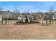 A playground in a common area with slides, swings and other equipment surrounded by a grassy lawn at 120 Trelawn St, Fort Mill, SC 29715