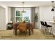 Spacious dining area with large wood table, tan leather chairs, and modern light fixture at 13124 Hampton Bay Ln, Charlotte, NC 28262