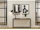 Modern entryway with black metal console table, framed artwork, and full-length mirrors at 13124 Hampton Bay Ln, Charlotte, NC 28262