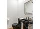 Modern black and white bathroom with pedestal sink and elegant mirror at 1333 Queens Rd # D4, Charlotte, NC 28207