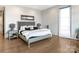 Spacious bedroom with plush bed, hardwood floors, and large window at 1333 Queens Rd # D4, Charlotte, NC 28207