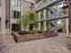 Shared courtyard with brick paving, landscaping, and metal staircase at 1333 Queens Rd # D4, Charlotte, NC 28207