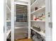 Well-organized pantry with stainless steel wine cooler and ample shelving at 1333 Queens Rd # D4, Charlotte, NC 28207