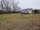 Large backyard with some trees and a fire pit at 13655 Broadway Ave, Midland, NC 28107