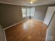 Bright bedroom with laminate wood floors and neutral walls at 13655 Broadway Ave, Midland, NC 28107