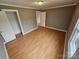 Well-lit bedroom with laminate flooring and ample closet space at 13655 Broadway Ave, Midland, NC 28107