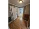 Bright hallway with wood floors, leading to kitchen and bathroom at 13655 Broadway Ave, Midland, NC 28107