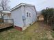 Side view of house showing gray siding and small deck at 13655 Broadway Ave, Midland, NC 28107