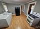 White appliances and wood cabinets in this galley kitchen at 13655 Broadway Ave, Midland, NC 28107