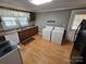 Galley kitchen with washer, dryer and wood cabinets at 13655 Broadway Ave, Midland, NC 28107