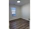 Simple bedroom with hardwood floors and a window at 1638 Hudson Graham Ln, Charlotte, NC 28216