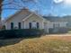 Ranch house with gray siding, landscaping, and a walkway at 1638 Hudson Graham Ln, Charlotte, NC 28216