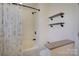 Cozy bathroom with tub/shower, decorative curtain, stylish black shelving, and a neutral color palette at 1687 Riverdale Dr, Rock Hill, SC 29732