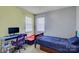 This bedroom has light grey and light green walls, two windows and a blue bed set at 1687 Riverdale Dr, Rock Hill, SC 29732