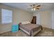 Well-lit bedroom offers neutral carpet, a ceiling fan, and a storage cabinet for organization at 1687 Riverdale Dr, Rock Hill, SC 29732