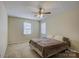 Cozy bedroom features neutral decor, a ceiling fan, and natural light from two windows at 1687 Riverdale Dr, Rock Hill, SC 29732