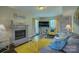 Sunlit living room featuring a brick fireplace and a large grey sofa at 1687 Riverdale Dr, Rock Hill, SC 29732