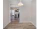 Dining area with view into kitchen and wood-look floors at 17629 Delmas Dr, Cornelius, NC 28031