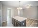 Bright kitchen with an island and access to adjacent dining area at 17629 Delmas Dr, Cornelius, NC 28031