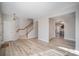 Light and airy living room with stairs and wood-look floors at 17629 Delmas Dr, Cornelius, NC 28031