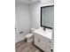 Bathroom with white vanity, quartz countertop and wood-look floors at 1945 Hendricks St, Rock Hill, SC 29732