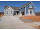 Two-story home featuring stone accents, blue siding, an attached two-car garage and an expansive concrete driveway at 1945 Hendricks St, Rock Hill, SC 29732