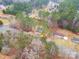 Aerial view of a house nestled in a wooded area, with roads and other houses visible at 203 Bud Black Rd, Crouse, NC 28033