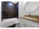 Modern bathroom with dark tile shower surround,granite vanity, and updated fixtures at 203 Bud Black Rd, Crouse, NC 28033