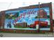 A mural depicting scenes from Cherryville, including baseball, transportation, and school at 203 Bud Black Rd, Crouse, NC 28033