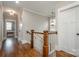 Upstairs hallway with hardwood floors and access to bedrooms at 2358 Morton St, Charlotte, NC 28208