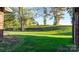 Open backyard with a grassy area and mature trees at 241 Pinecrest Ct, Taylorsville, NC 28681