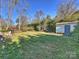 Landscaped backyard with storage shed and seating area at 2625 Croydon Rd, Charlotte, NC 28209