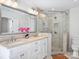 Bathroom with double vanity, large mirror, and walk-in shower at 2625 Croydon Rd, Charlotte, NC 28209