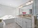 Elegant bathroom with double vanity, soaking tub, and walk-in shower at 2625 Croydon Rd, Charlotte, NC 28209