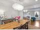 Elegant dining room featuring a rustic wood table and modern chandelier at 2625 Croydon Rd, Charlotte, NC 28209