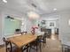 Farmhouse dining room with a long wooden table and chandelier at 2625 Croydon Rd, Charlotte, NC 28209