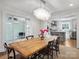 Bright dining room with a rustic wooden table and a view of the kitchen at 2625 Croydon Rd, Charlotte, NC 28209