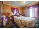 Bedroom with floral bedding and wood dresser at 2648 Roslyn Ave, Charlotte, NC 28208